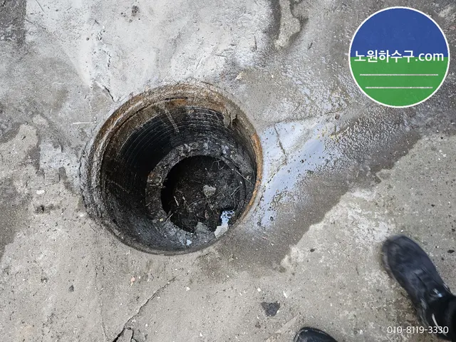 콘크리트 바닥에 뚫린 원형 오수받이 입구